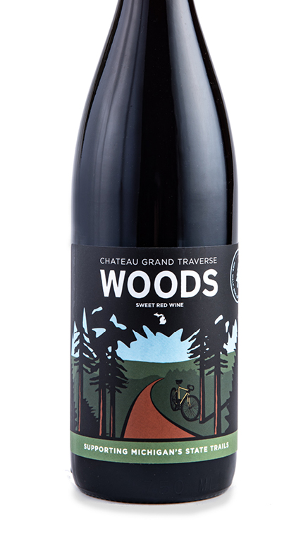 a bottle of Woods Sweet Red Wine supporting Michigan's state trails from Chateau Grand Traverse