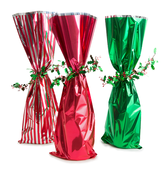 3 unidentified bottles of wine in decorative christmas wrapping paper with vinyl holly berry ties